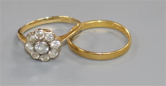 An 18ct gold and diamond cluster ring and a 22ct gold wedding band.